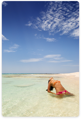 A woman sun bathing on a beach in Venezuela.